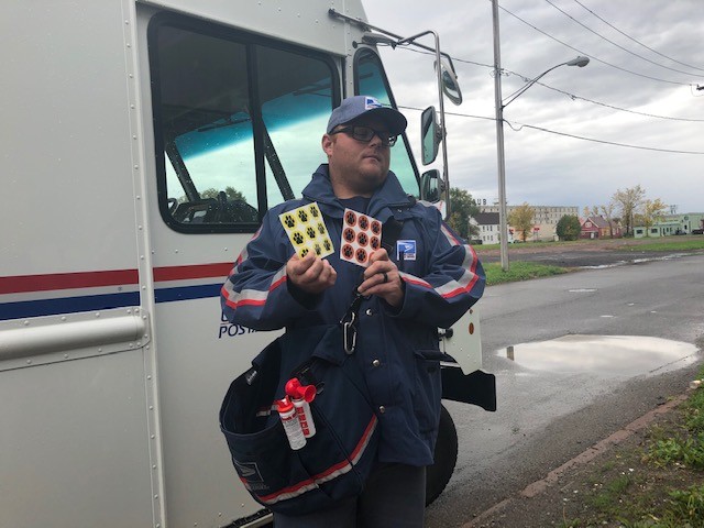 postal worker with paw print stickers