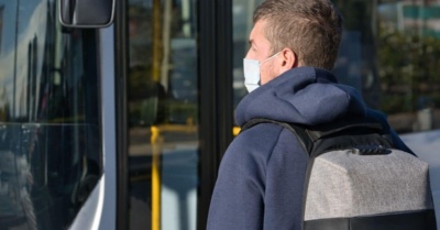 man on a bus wearing a covid mask