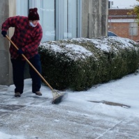 sweeping snow outside of salvation army