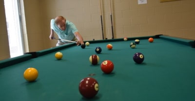 Landis Groves shoots pool at the Christian County Senior Center in July 2021. (Photo by Toni Riley)