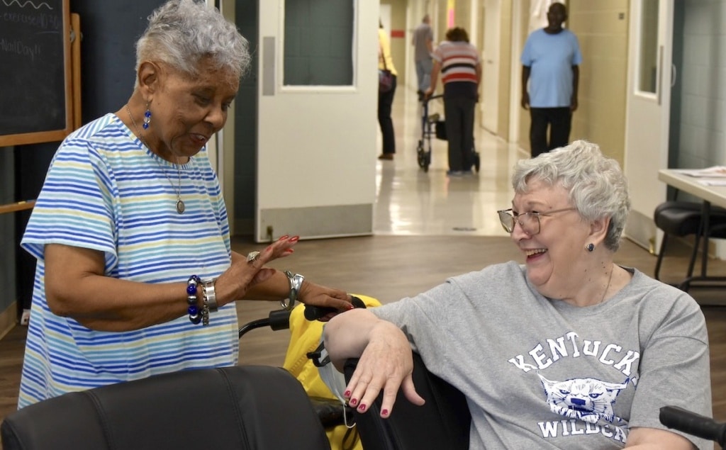 two women showing each other their nails at the christian county senior center