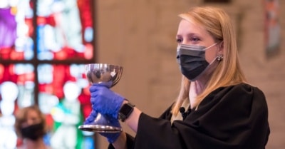 Rev. Carol Harston leads communion at Louisville's Highland Baptist Church. (Photo by Bill Campbell)