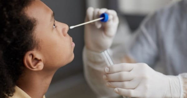 teenager getting nasal swab covid test