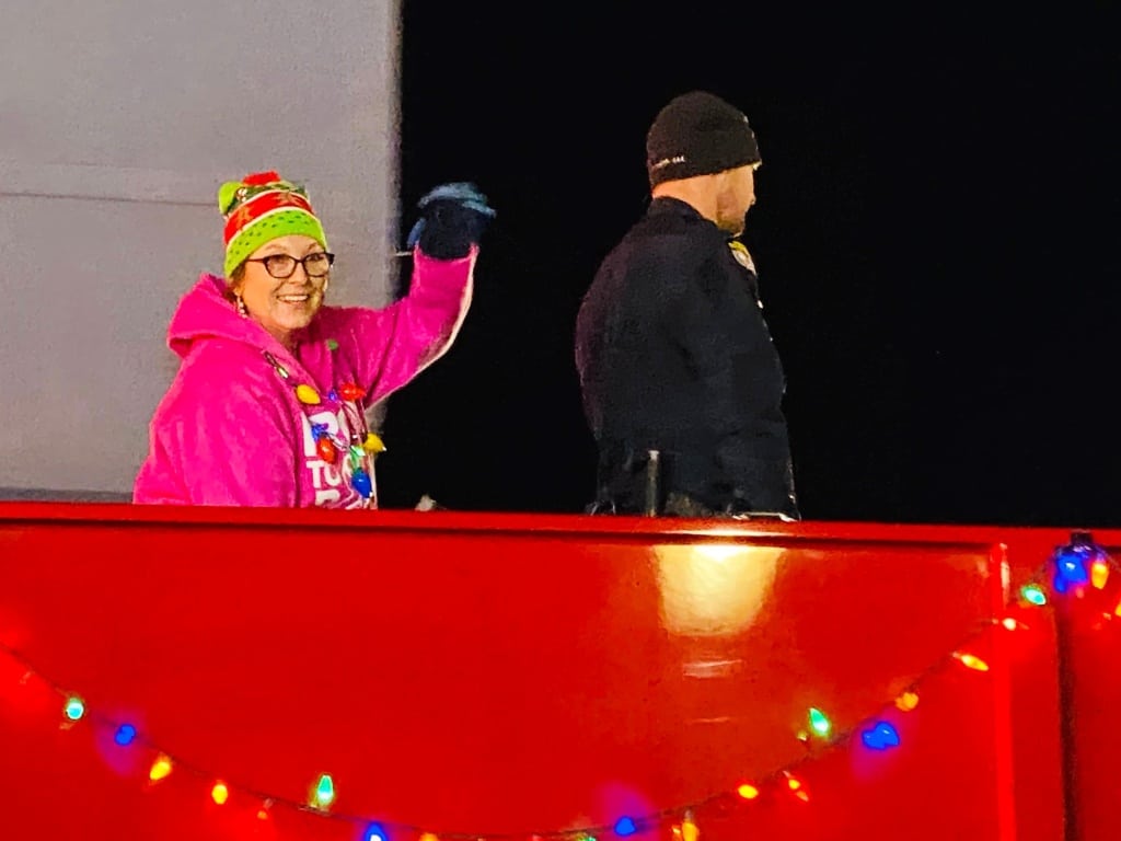 Summer Johnston waving from Christmas parade float