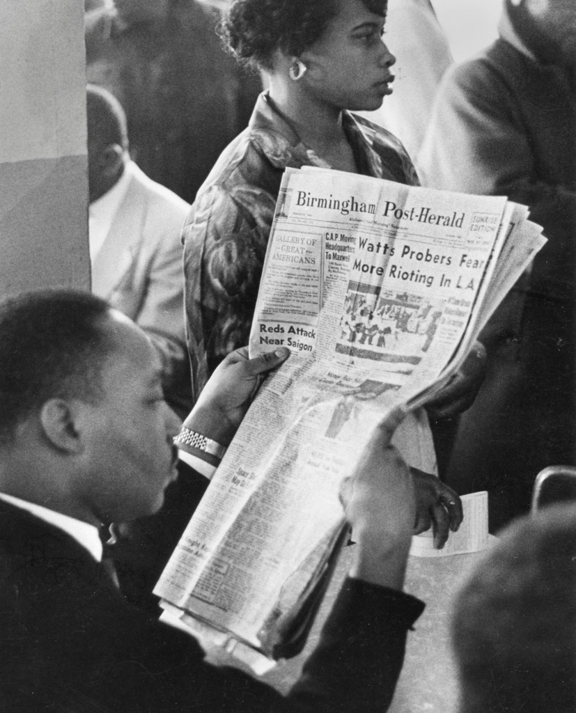 Martin Luther King Jr. reads newspaper