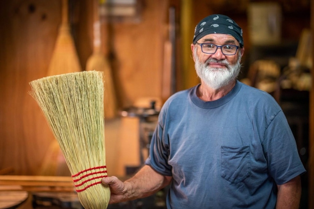 man holding broom