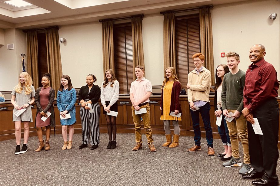 essay winners and lynch standing in council chambers