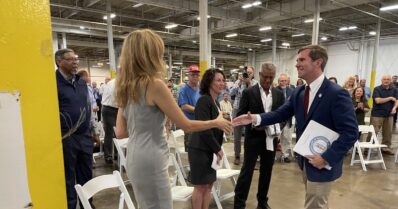 Gov. Andy Beshear shakes hands with Hollobus Technologies leadership on Wednesday, May 25, 2022, in Murray. (WKMS photo)