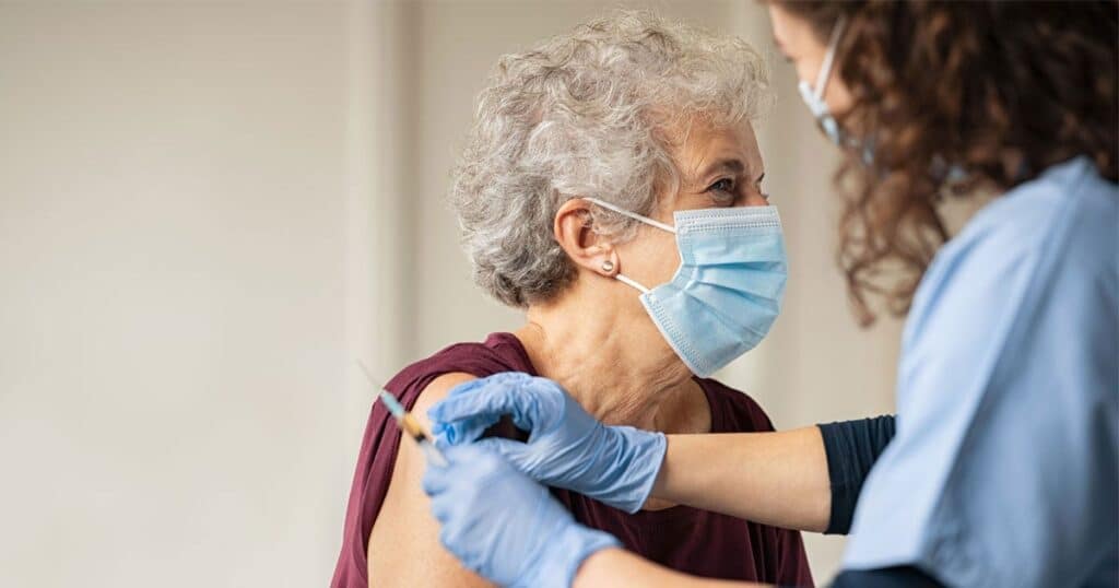 senior woman receiving vaccine