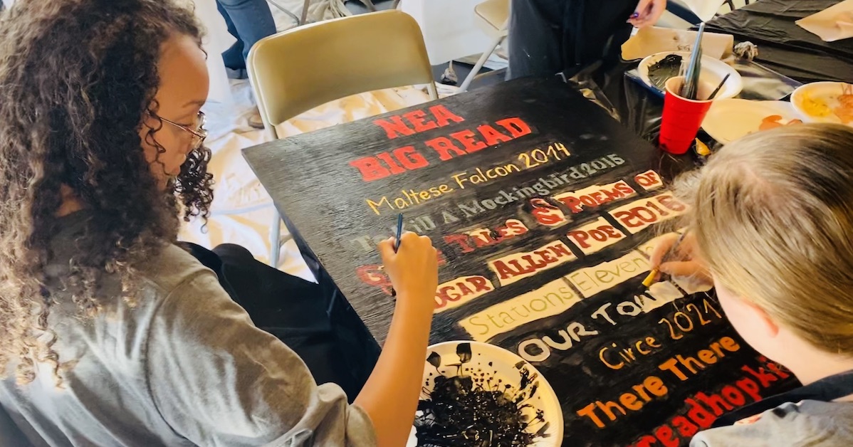Six students in the Big Read art camp painted large wooden panels with designs resembling book titles and other images related to the program. (Hoptown Chronicle photo by Jennifer P. Brown)