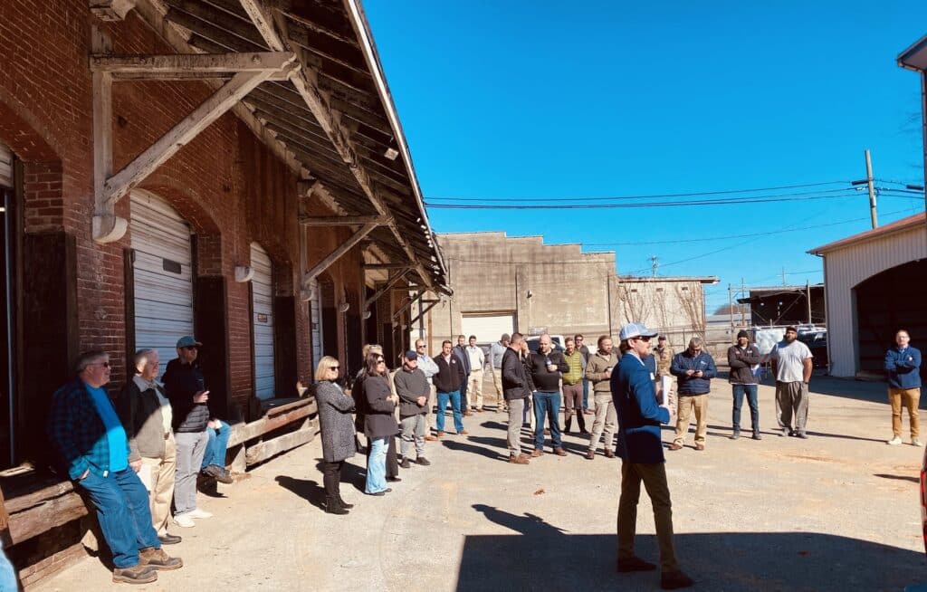 people standing in front of L&N Freight Station auction