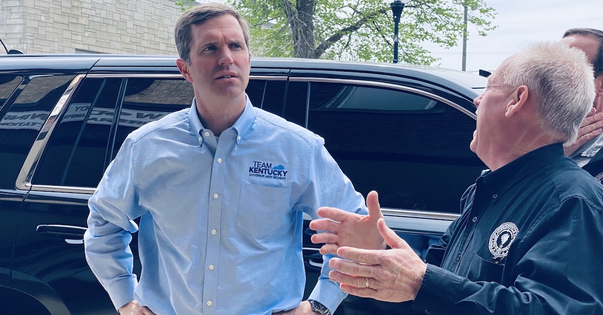 Gov. Andy Beshear stands on Friday, April 7, 2023, outside the Woody Winfree Fire and Transportation Museum at Mayor James R. Knight Jr. describes damages to building sustained in the March 31 storm. (Hoptown Chronicle photo by Jennifer P. Brown)