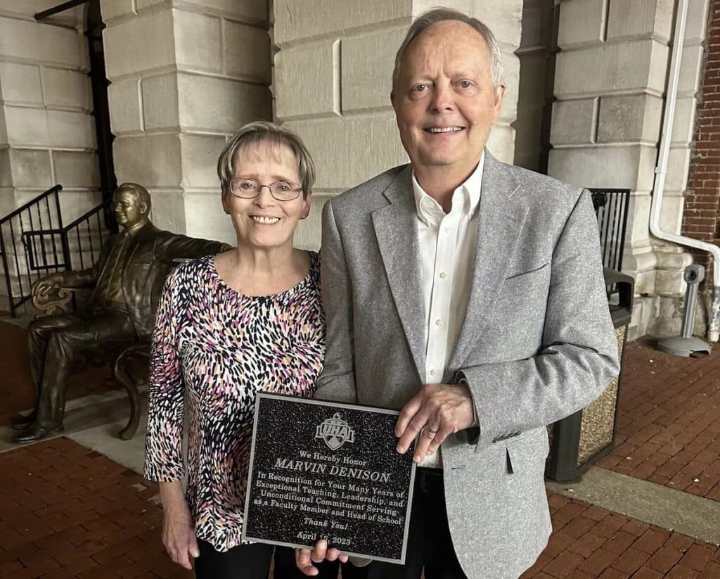 couple standing with plaque at UHA anniversary