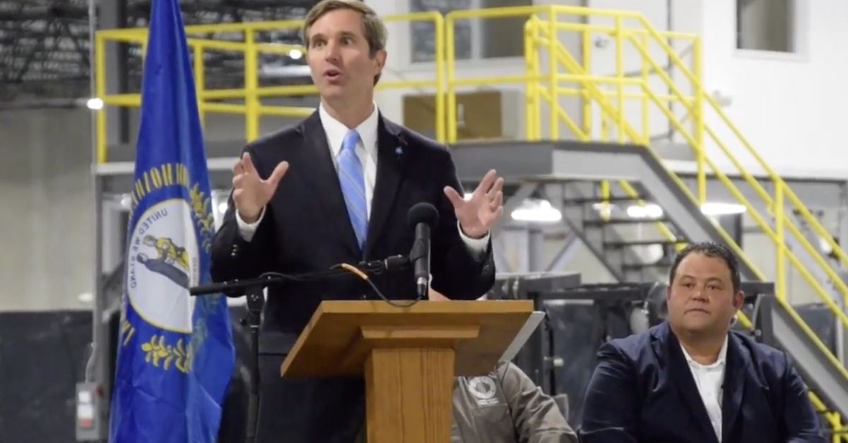 Randall Weddle, then a candidate for London mayor, listens as Gov. Andy Beshear helps celebrate the opening of WB Transport’s new warehouse in April 2022. (Screenshot with permission of WYMT)