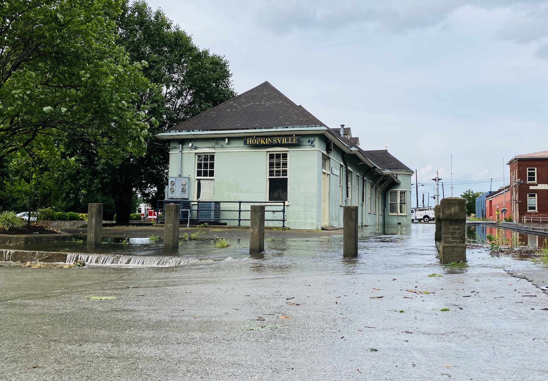 Flood water runs off the concrete apron surrounding the old L&N Train Depot on 10th Street following a severe storm late Wednesday afternoon, July 5, 2023. (Hoptown Chronicle photo by Jennifer P. Brown)