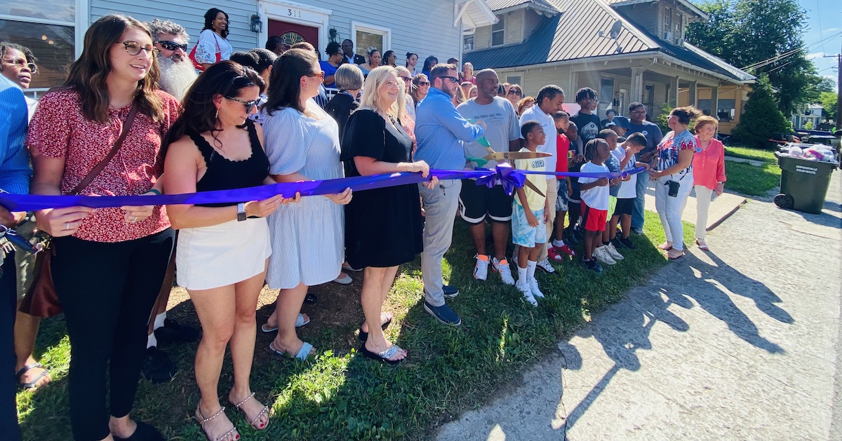 Members of the Leadership Hopkinsville-Christian County Class of 2022-23 and Men2Be students and mentors pose for a photograph Monday at the Bryan Street Challenge House that is the home of the mentoring program. (Hoptown Chronicle photo by Jennifer P. Brown)