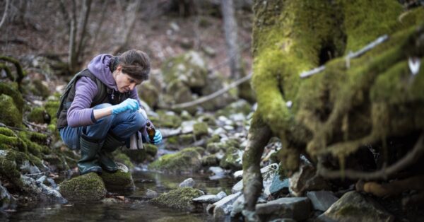 woman testing stream water