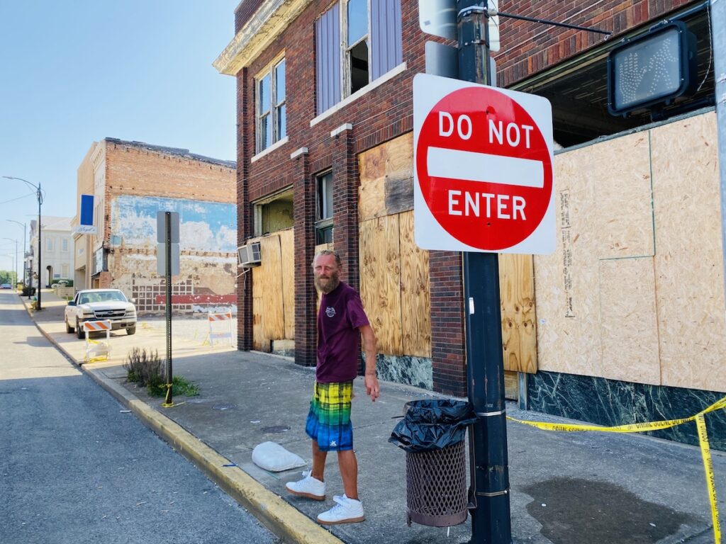 man in front of phoenix building