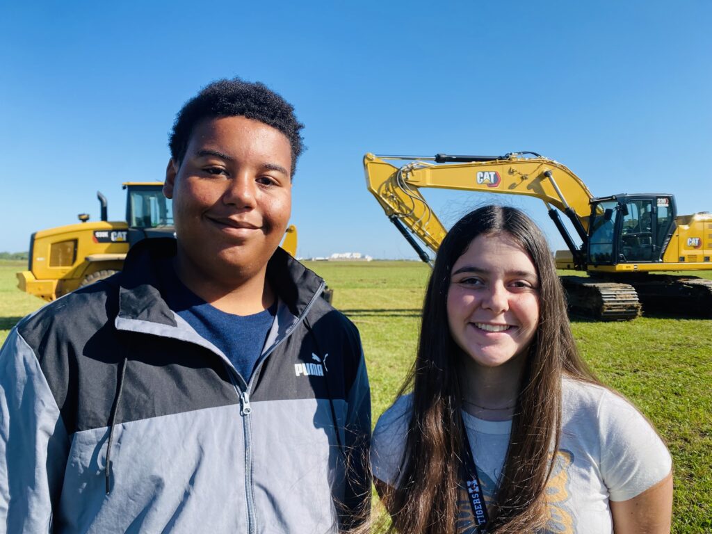 christian county high school students in front of construction equipment