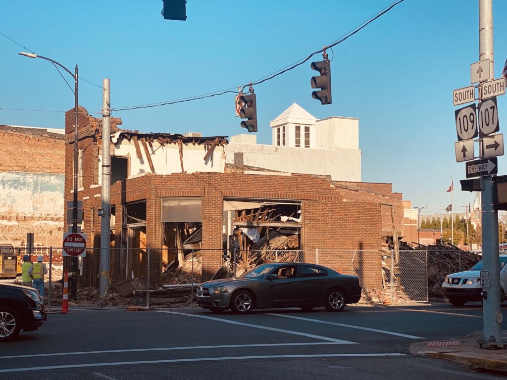 cars passing by half-demolished phoenix building