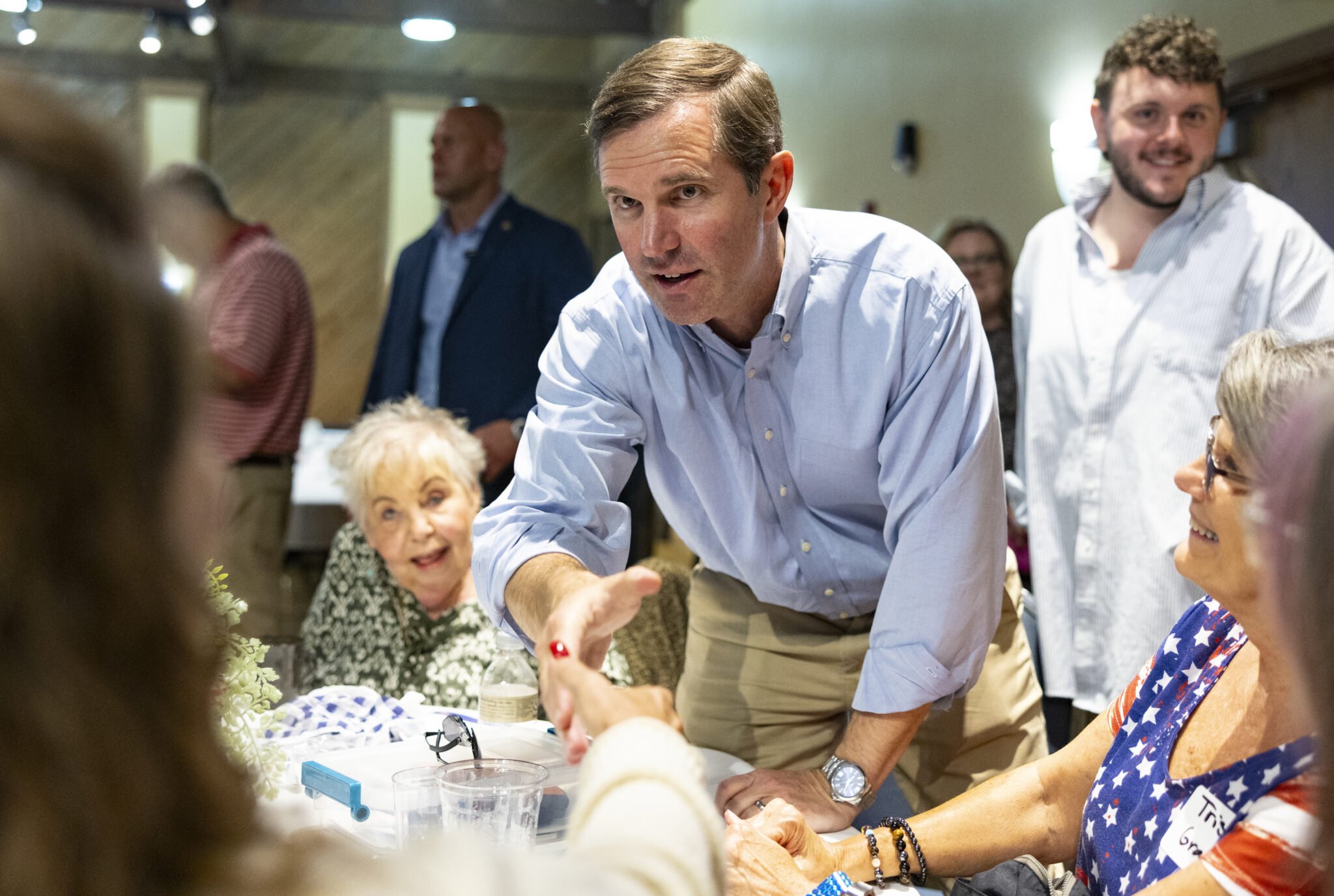 Gov. Andy Beshear shakes a supporter’s hand during the 26th annual Bean Dinner on Friday, Aug. 4, 2023. (Kentucky Lantern photo by Austin Anthony)