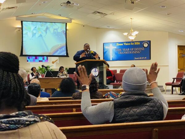 woman raising hands at MLK service