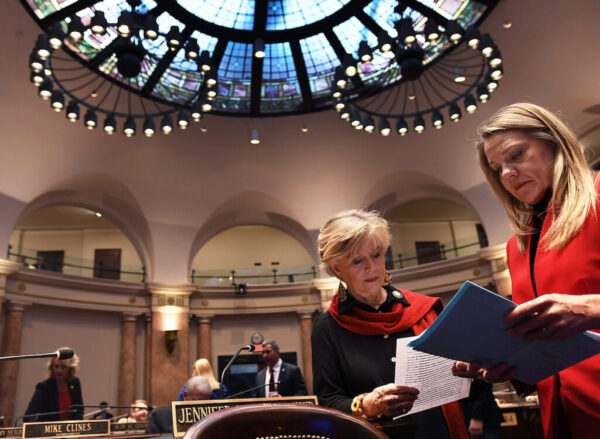 FRANKFORT, Jan. 10- Rep. Jennifer Decker, R-Waddy, (left), and Rep. Emily Callaway, R-Louisville, look over legislation before the start of the House session on Wednesday.