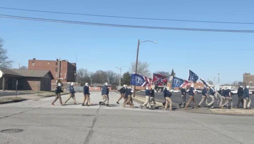 white supremacists walking with flags