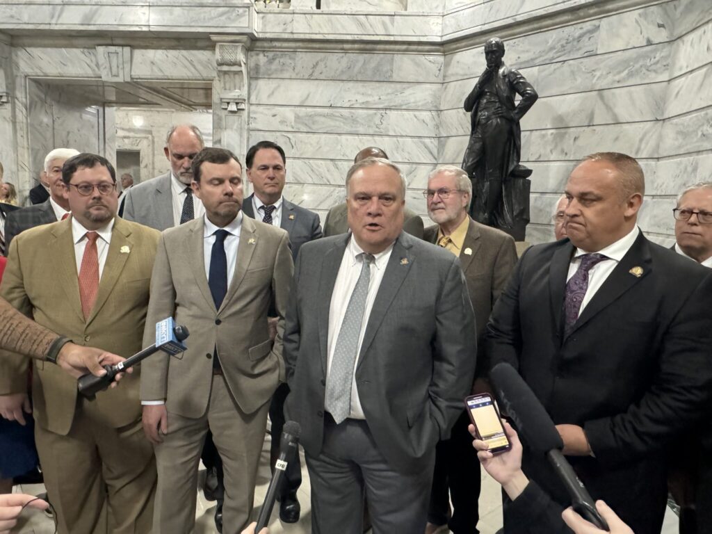 Men of the legislature gathered with Senate President Robert Stivers to talk to media after overriding Gov. Andy Beshear’s veto of a bill that preempted housing discrimination ordinances in Louisville and Lexington. (Kentucky Lantern photo by Liam Niemeyer)