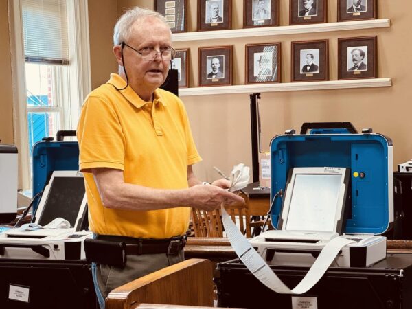 man folding tape from election results