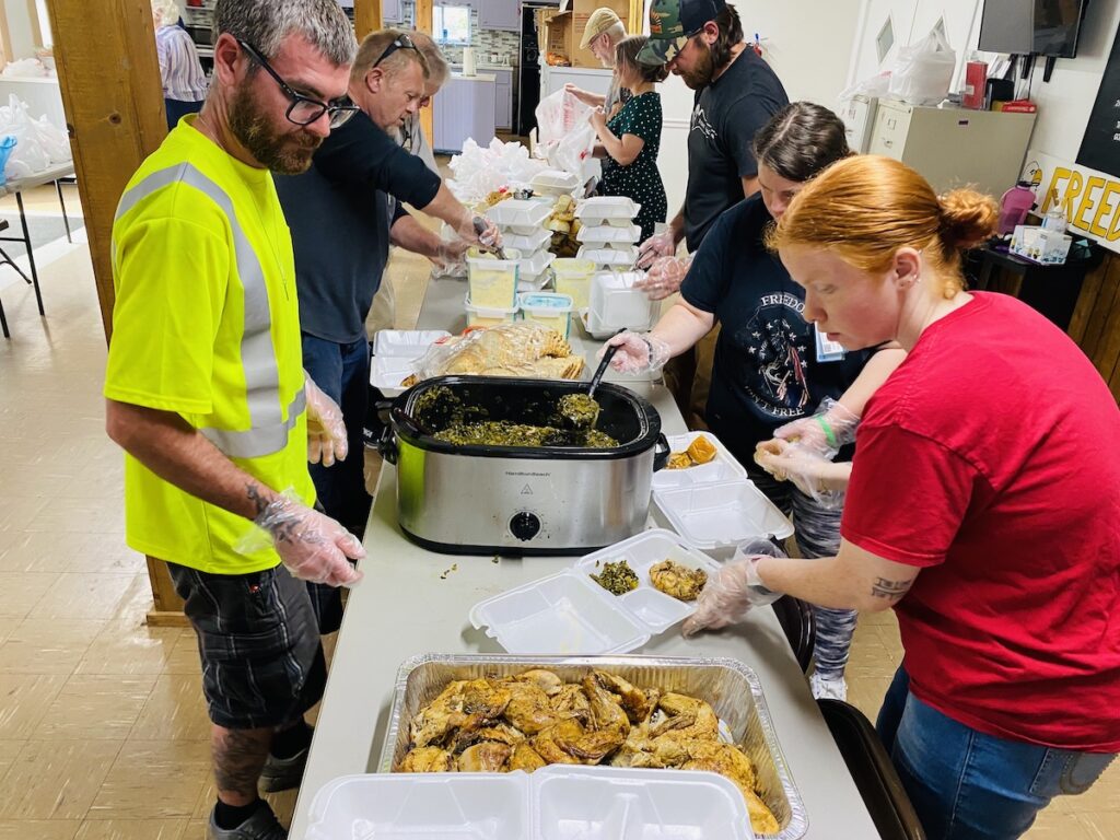 people in line for food at Breaking Bread Community Dinner Church