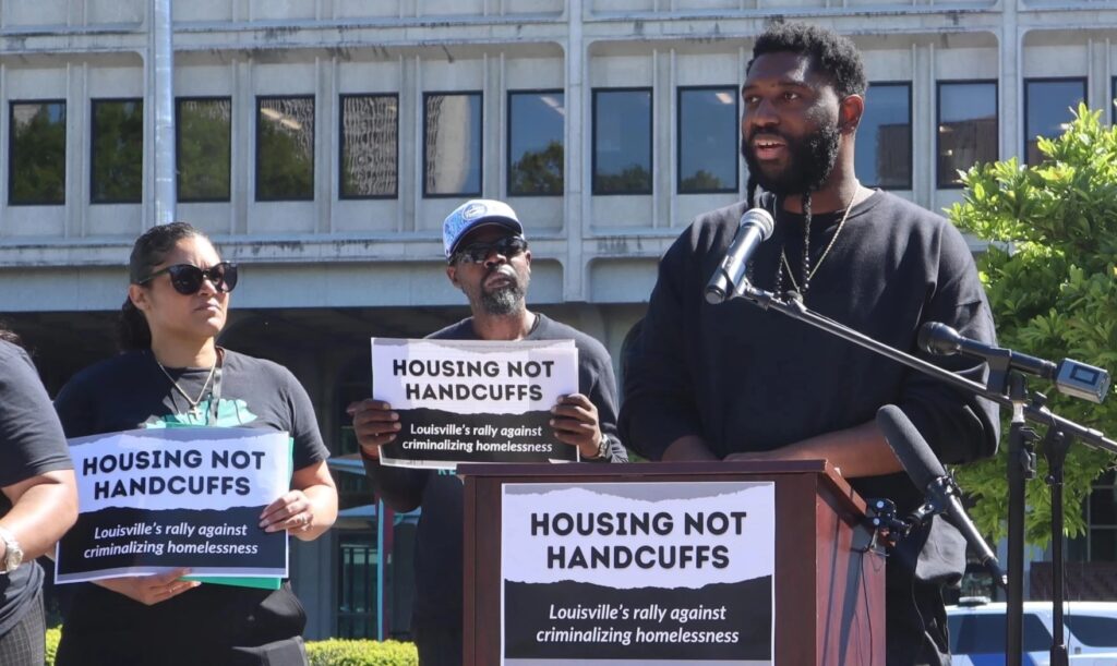 louisville homelessness rally participants holding signs