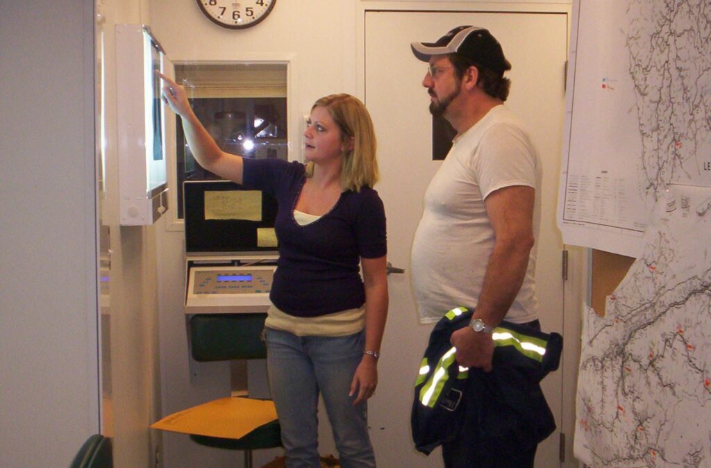 X-ray tech explaining the basics of a chest x-ray to a coal miner in Harlan County, KY as part of the  Enhanced Coal Workers' Health Surveillance Program (black lung screening). (National Institute for Occupational Safety and Health photo | Public domain)