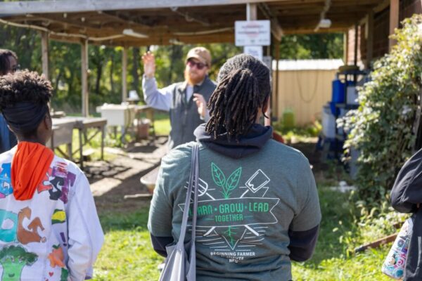 Back of person wearing Beginning Farmer Institute shirt