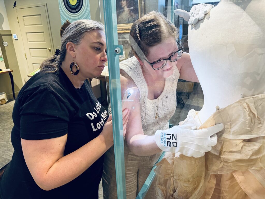 woman inspecting wedding dress