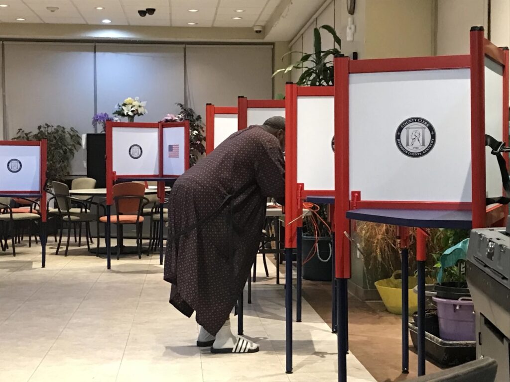 A resident of the Elliott Park apartments was the first one to vote, in his robes and slippers, on Election Day in 2022.