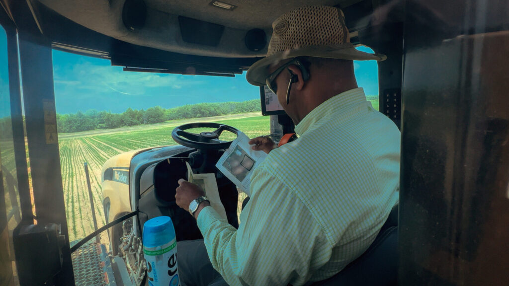 black farmer driving tractor