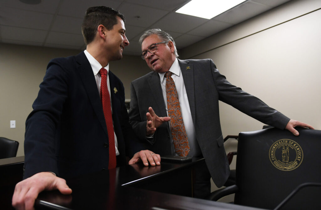 FRANKFORT, March 13 – Rep. Jacob Justice, R-Elkhorn City, (left) talks with House Committee on Local Government Chairman Rep. Randy Bridges, R-Paducah, before the start of Wednesday’s committee meeting.