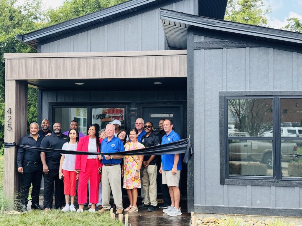 Members of Lincoln Real Estate Development Group standing in front of house