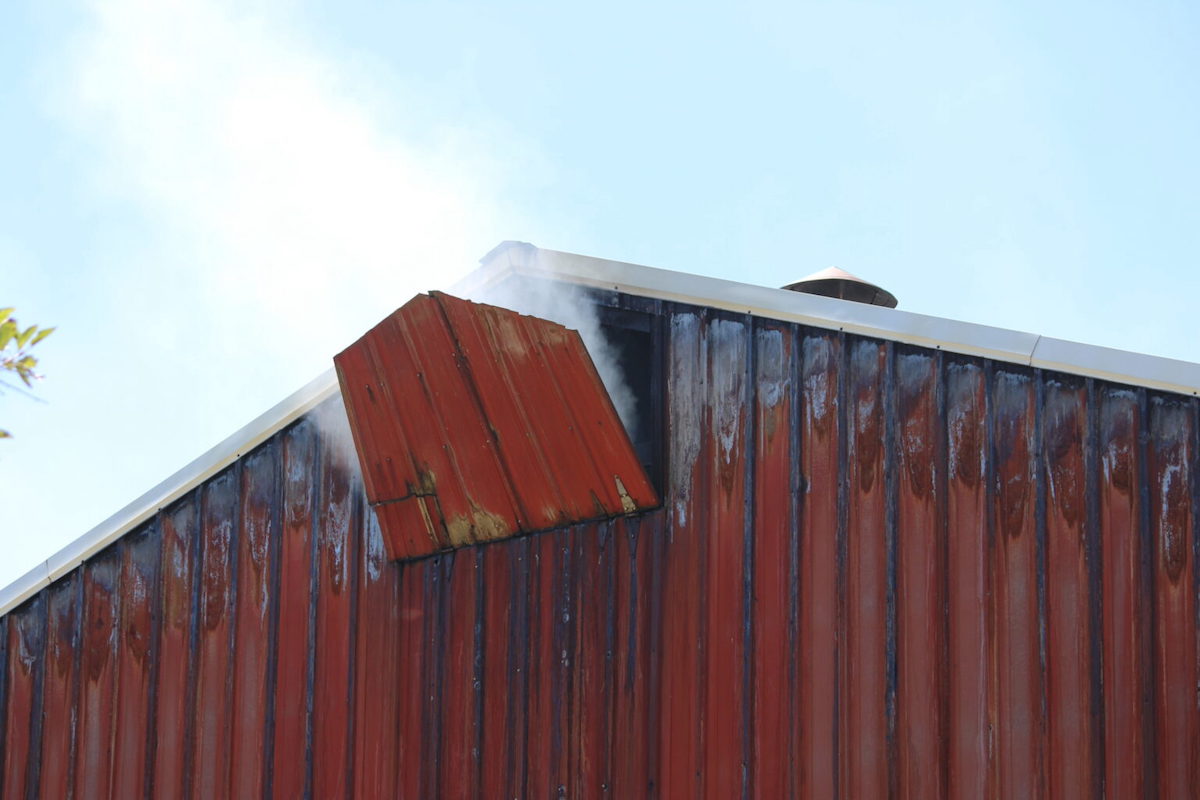 White smoke escapes from a vent on this tobacco barn on Kentucky 2547 South in Calloway County. (Murray Sentinel photo by Jessica Paine)