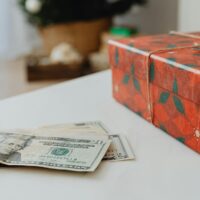 money next to christmas gift