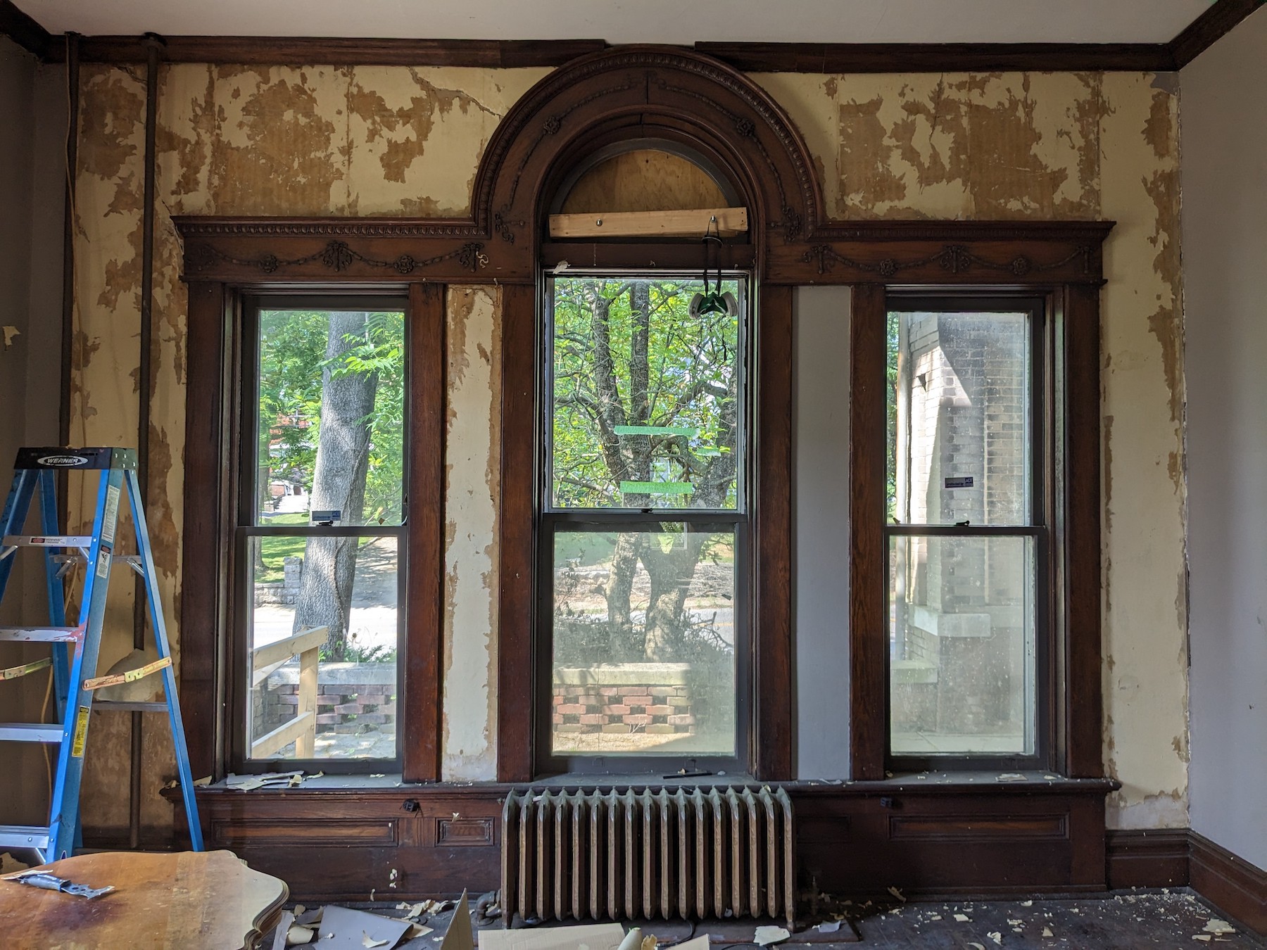 The parlor of the Dalton house with its damaged radiator shortly after Grace and Brendan Abernethy bought the house. (Photo by Grace Abernethy)