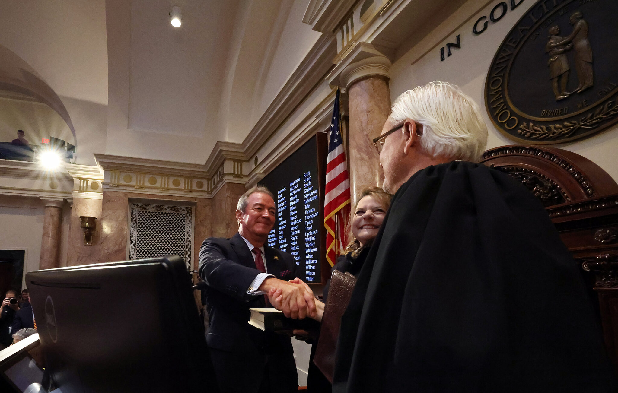 House Speaker David W. Osborne, R-Prospect, is congratulated by U.S. District Judge Gregory F. Van Tatenhove after his swearing in. The speaker’s wife, Loren Hebel Osborne, looks on. (LRC Public Information)