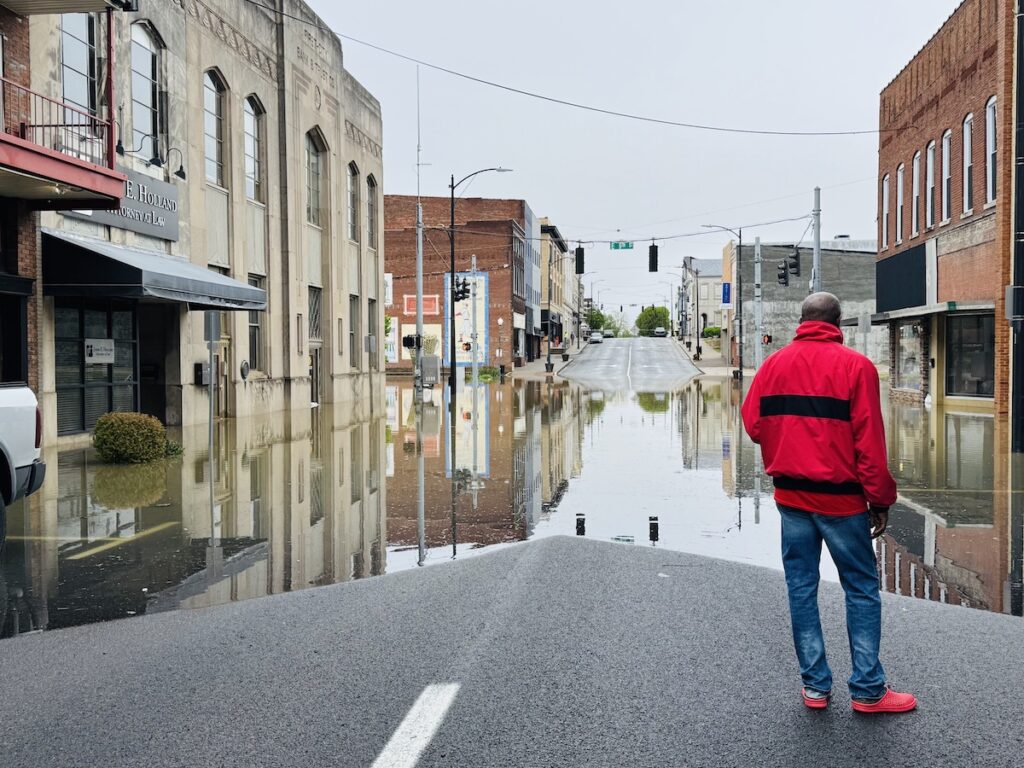 man standing at flood edge