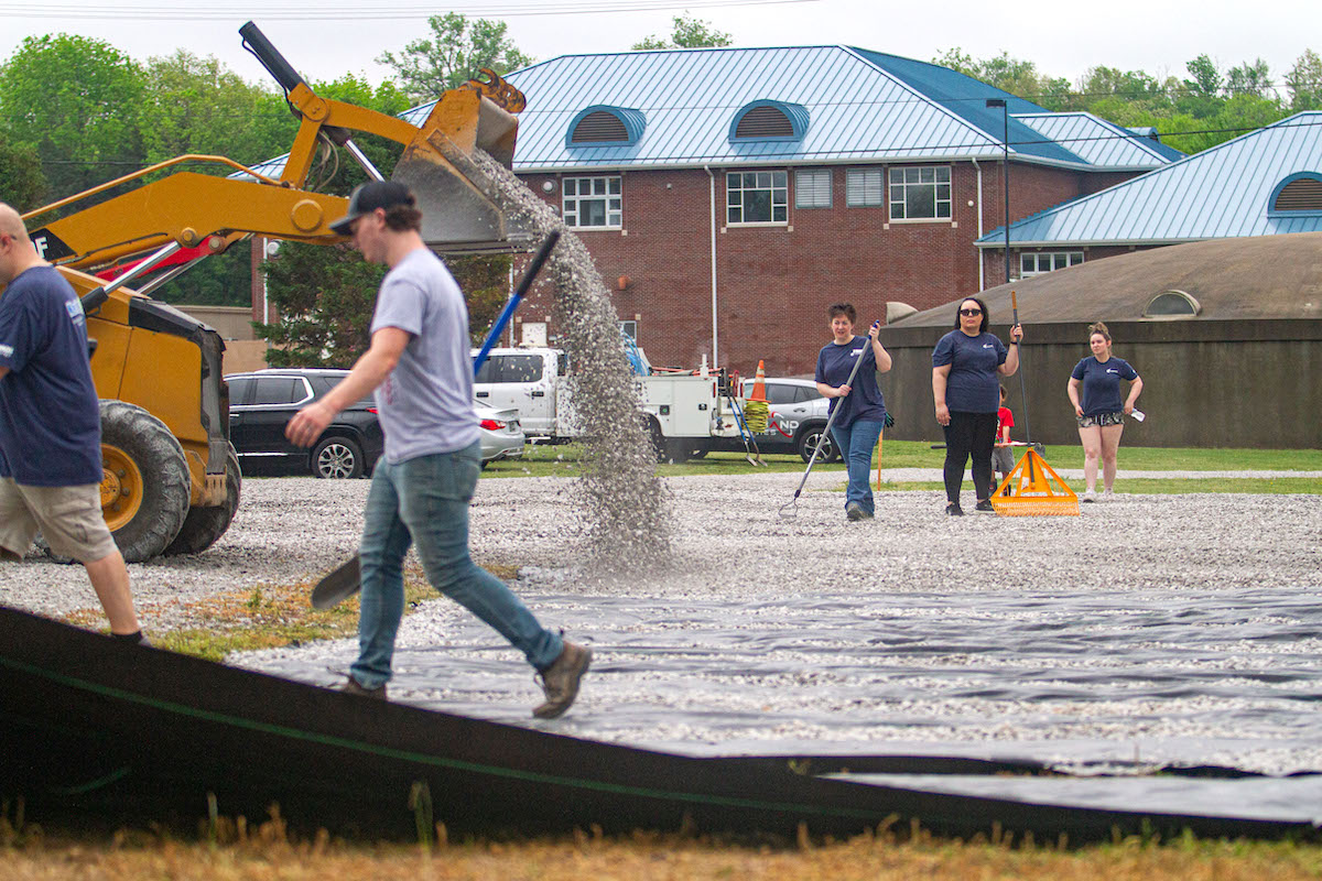 Leadership Christian County class members and community partners spread gravel Friday, April 25, 2025, at Jeffers Bend to expand the size of the nature center’s parking lot. (Photo by Samantha Fry)
