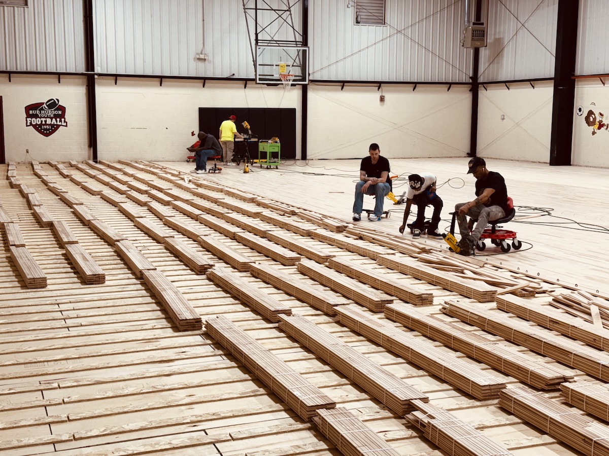 A crew for Conrad Floors, based in Smiths Grove, Kentucky, works on May 15, 2025, to install a new gym floor at the Boys and Girls Club of Hopkinsville-Christian County. The installation is part of a gym renovation honoring the parents of Hopkinsville native Tommy Wade. (Hoptown Chronicle photo by Jennifer P. Brown)