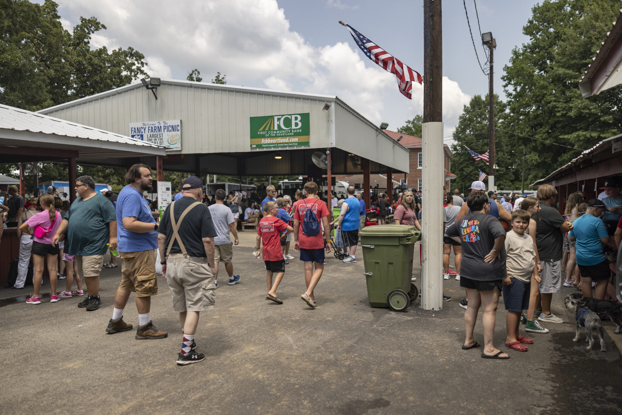 People walk by pavilions on Saturday, Aug. 3, 2024, during St. Jerome Picnic in Fancy Farm, Ky. (Austin Anthony for the Kentucky Lantern)