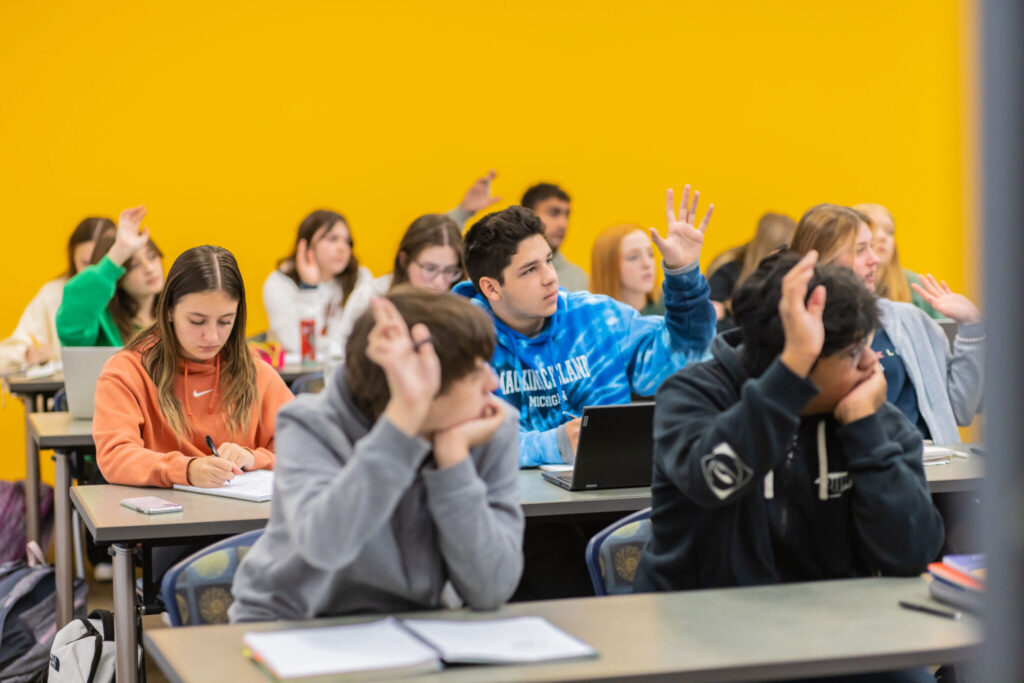 students raising hands