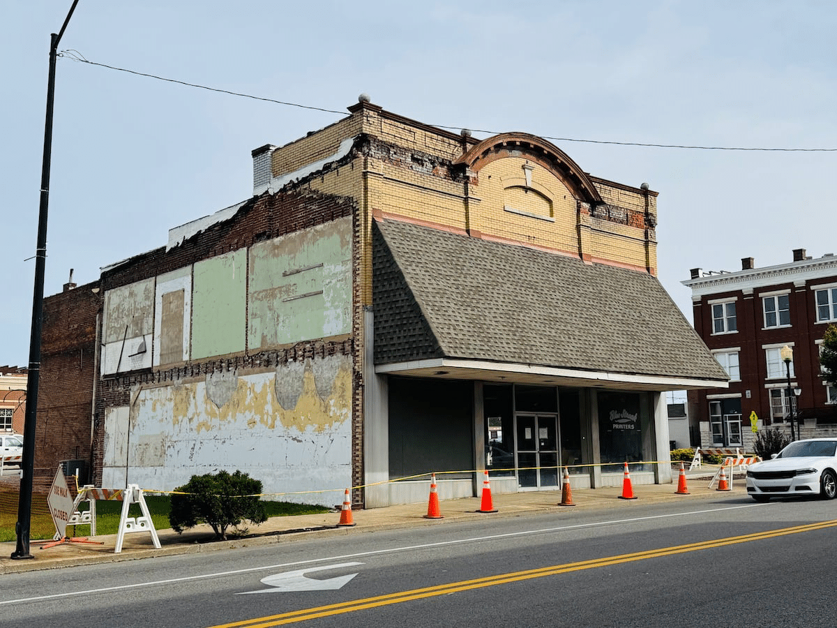 blue streak building with orange cones and caution tape out front