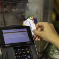 hand sliding ebt card through processor